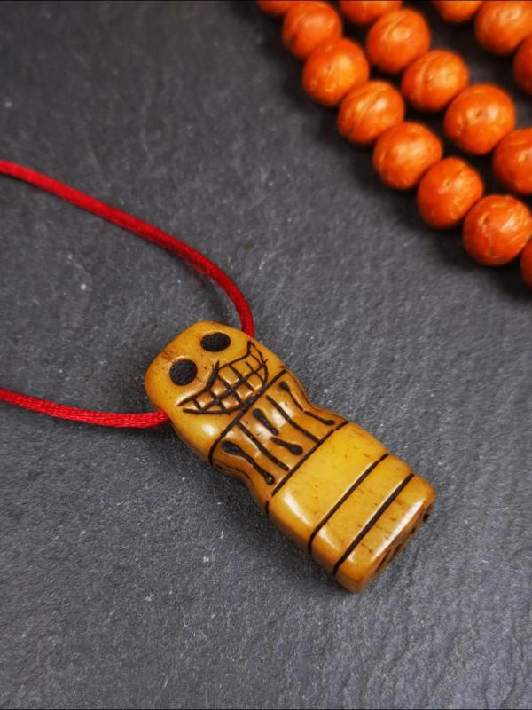 This skull seal amulet was made by Tibetan craftsmen and come from Hepo Town, Baiyu County, the birthplace of the famous Tibetan handicrafts. It's made of yak bone,yellow color,carved skull shape,and OM letter at the bottom,height is inches. You can make it a pendant, keychain.
