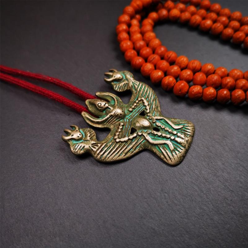 This Garuda is collected from Yaqing Monastery Baiyu County Tibet,it's a handmade badge,amulet pandent, made of copper,about 80 years old. You can wear it as amulet pendant, or make it into wall decoration, hang on the door as a protector,or just put it on your desk,as an ornament.