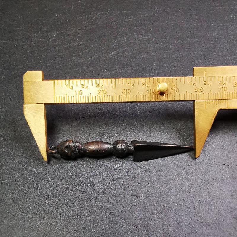 This phurba was made by Tibetan craftsmen and come from Hepo Town, Baiyu County, the birthplace of the famous Tibetan handicrafts. It is black color and 2.48" length,the upper part is Shmashana Adhipati skull, the lower part is a Dorje Phurba.