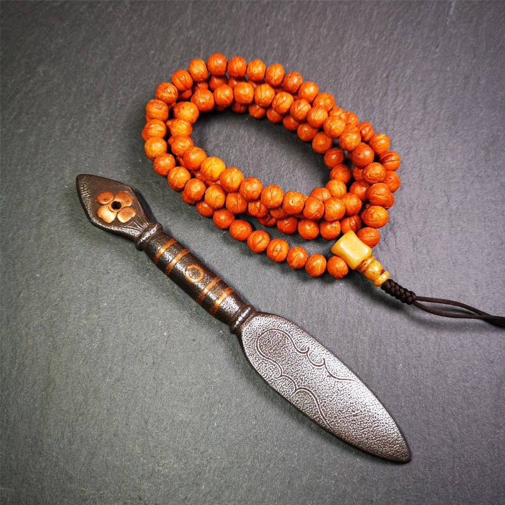 This kila / phurba was handmade by Tibetan craftsmen from Tibet in 2000s. It's a kila dagger,made of cold iron, carved cloud pattern, inlaid red copper, made into a dzi pattern on handle, and the petals of the tail hanging ring