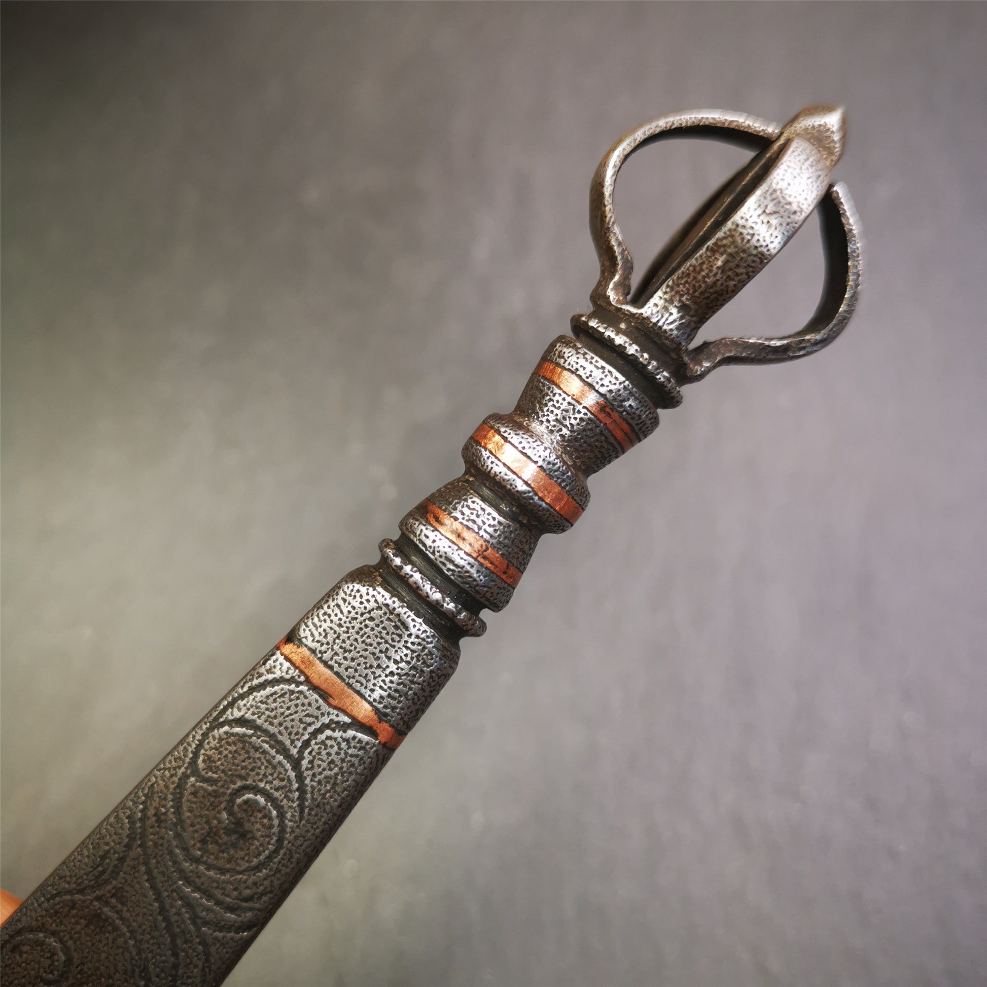 This phurba / vajra sword was handmade by Tibetan craftsmen from Tibet in 1990.It is Fire Vajra Sword of Wisdom Buddha Manjushri,made of cold iron, carved cloud pattern, inlaid red copper, made into 3 line on handle, and the half vajra at the tail.