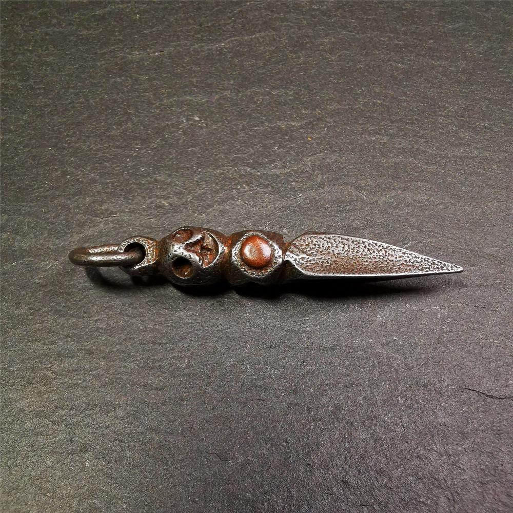 This phurba was made by Tibetan craftsmen and come from Hepo Town, Baiyu County,Tibet. Its upper part is Shmashana Adhipati skull, the lower part is a Dorje Phurba,and a copper dot inlaid on the waist of the phurba