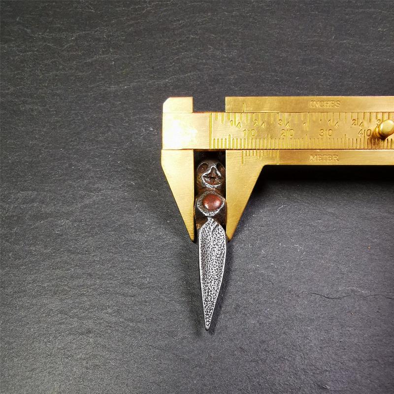 This phurba was made by Tibetan craftsmen and come from Hepo Town, Baiyu County,Tibet. Its upper part is Shmashana Adhipati skull, the lower part is a Dorje Phurba,and a copper dot inlaid on the waist of the phurba