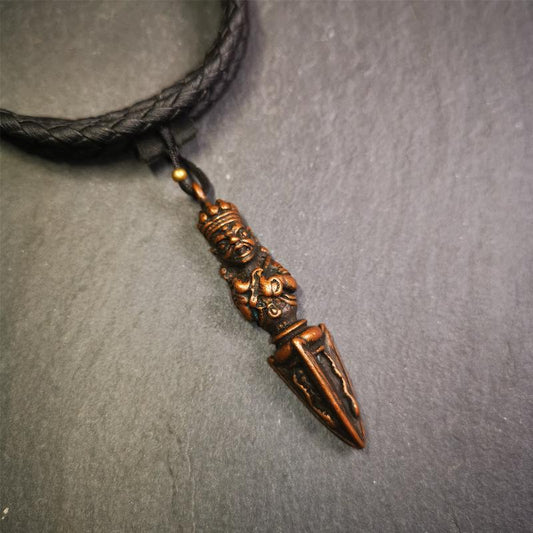 This vintage Phurba pendant was collected from Rega Monastery(Baiyu,Tibet),handmade of copper. It has a statue of Vajrapani on the top and a phurba on the lower part, measuring about 2.36 inches by 0.47 inch.