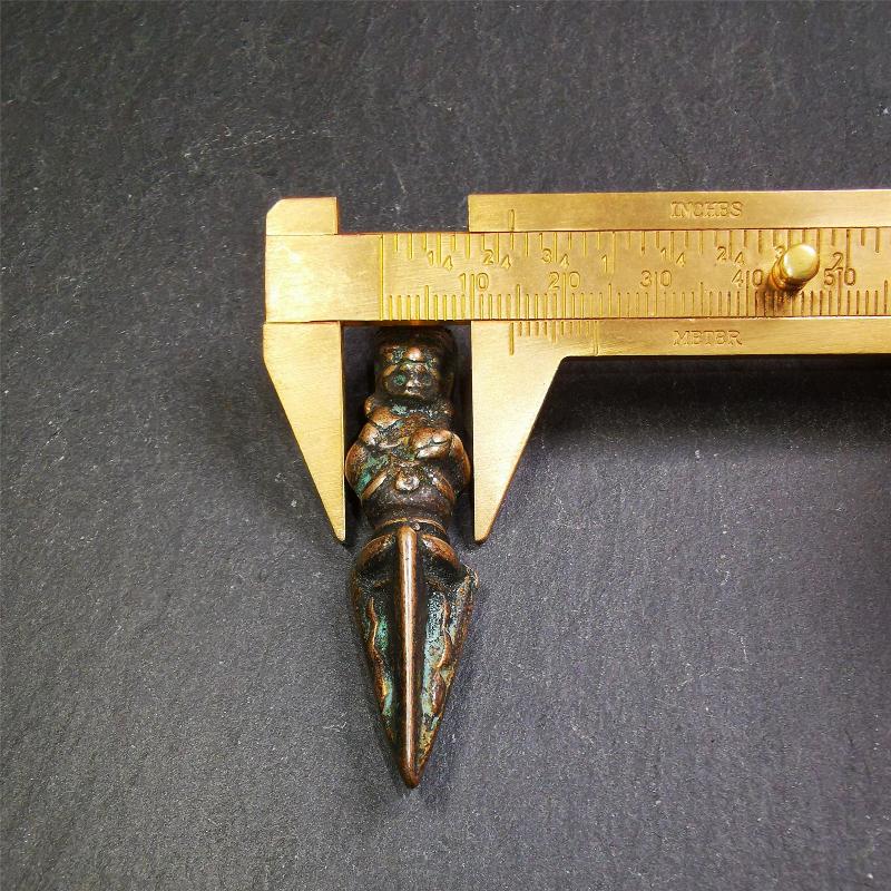 This vintage Phurba pendant was collected from Rega Monastery(Baiyu,Tibet),handmade of copper. It has a statue of Vajrapani on the top and a phurba on the lower part, measuring about 2.36 inches by 0.47 inch.