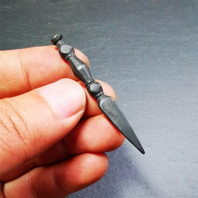 This handmade Dorje Phurba was crafted by Tibetan craftsmen from Hepo Town, Baiyu County, Tibet. The length is 2.2 inches,black color,the upper part is a vajra, and the lower part is a phurba.
