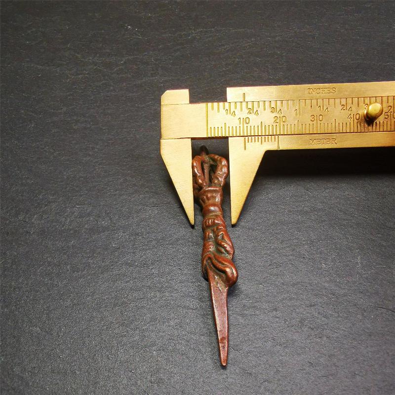 This vintage Phurba pendant was collected from gengqing Monastery(Derge,Tibet),handmade of copper. It is total 2.6 inches,brown color,on top of it is a dragon, the tail of the dragon is half vajra, from the dragon's mouth comes a phurba.