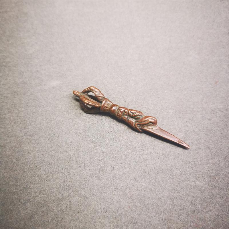 This vintage Phurba pendant was collected from gengqing Monastery(Derge,Tibet),handmade of copper. It is total 2.6 inches,brown color,on top of it is a dragon, the tail of the dragon is half vajra, from the dragon's mouth comes a phurba.