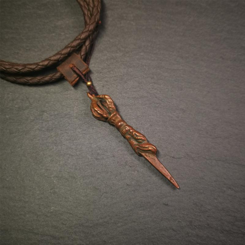 This vintage Phurba pendant was collected from gengqing Monastery(Derge,Tibet),handmade of copper. It is total 2.6 inches,brown color,on top of it is a dragon, the tail of the dragon is half vajra, from the dragon's mouth comes a phurba.