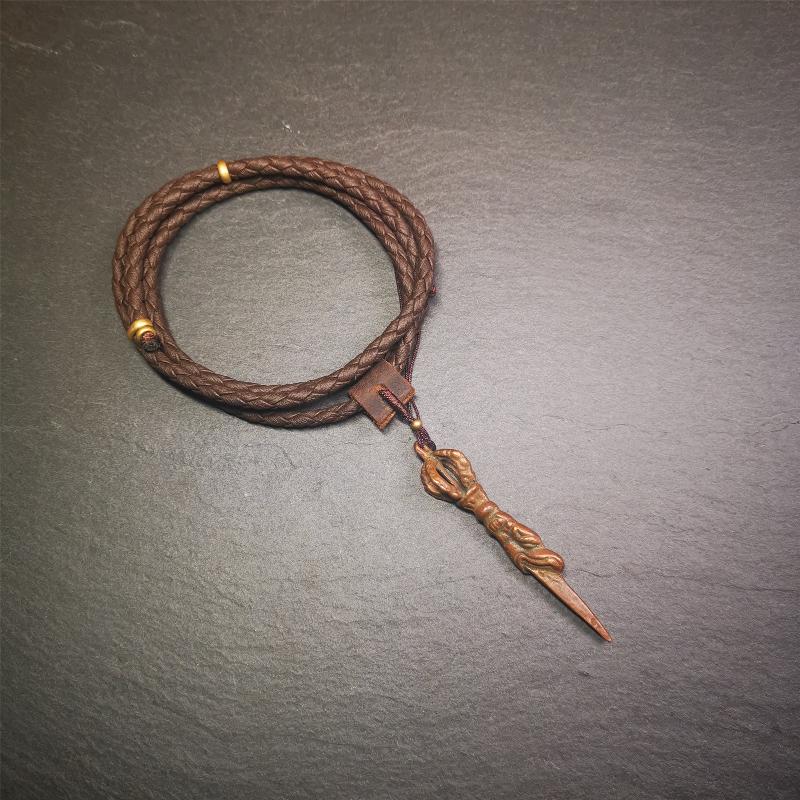 This vintage Phurba pendant was collected from gengqing Monastery(Derge,Tibet),handmade of copper. It is total 2.6 inches,brown color,on top of it is a dragon, the tail of the dragon is half vajra, from the dragon's mouth comes a phurba.