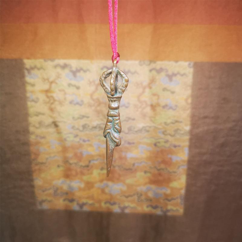 This vintage Phurba pendant was collected from gengqing Monastery(Derge,Tibet),handmade of copper. It is total 2.6 inches,brown color,on top of it is a dragon, the tail of the dragon is half vajra, from the dragon's mouth comes a phurba.