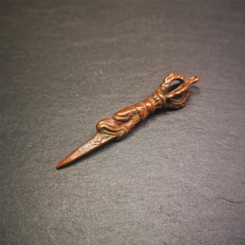 This vintage Phurba pendant was collected from gengqing Monastery(Derge,Tibet),handmade of copper. It is total 2.6 inches,brown color,on top of it is a dragon, the tail of the dragon is half vajra, from the dragon's mouth comes a phurba.
