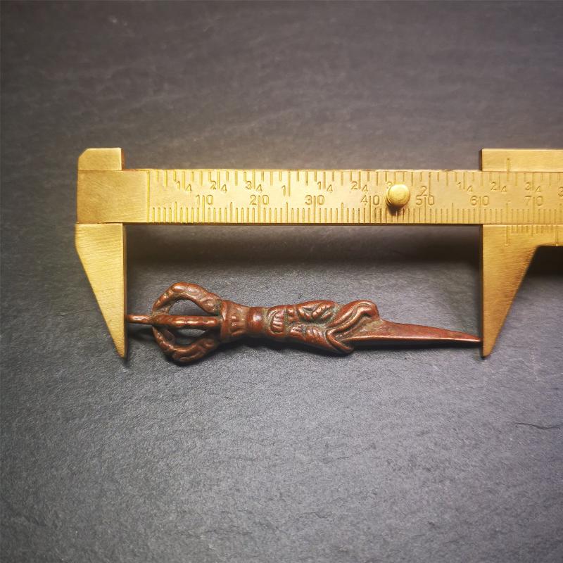 This vintage Phurba pendant was collected from gengqing Monastery(Derge,Tibet),handmade of copper. It is total 2.6 inches,brown color,on top of it is a dragon, the tail of the dragon is half vajra, from the dragon's mouth comes a phurba.