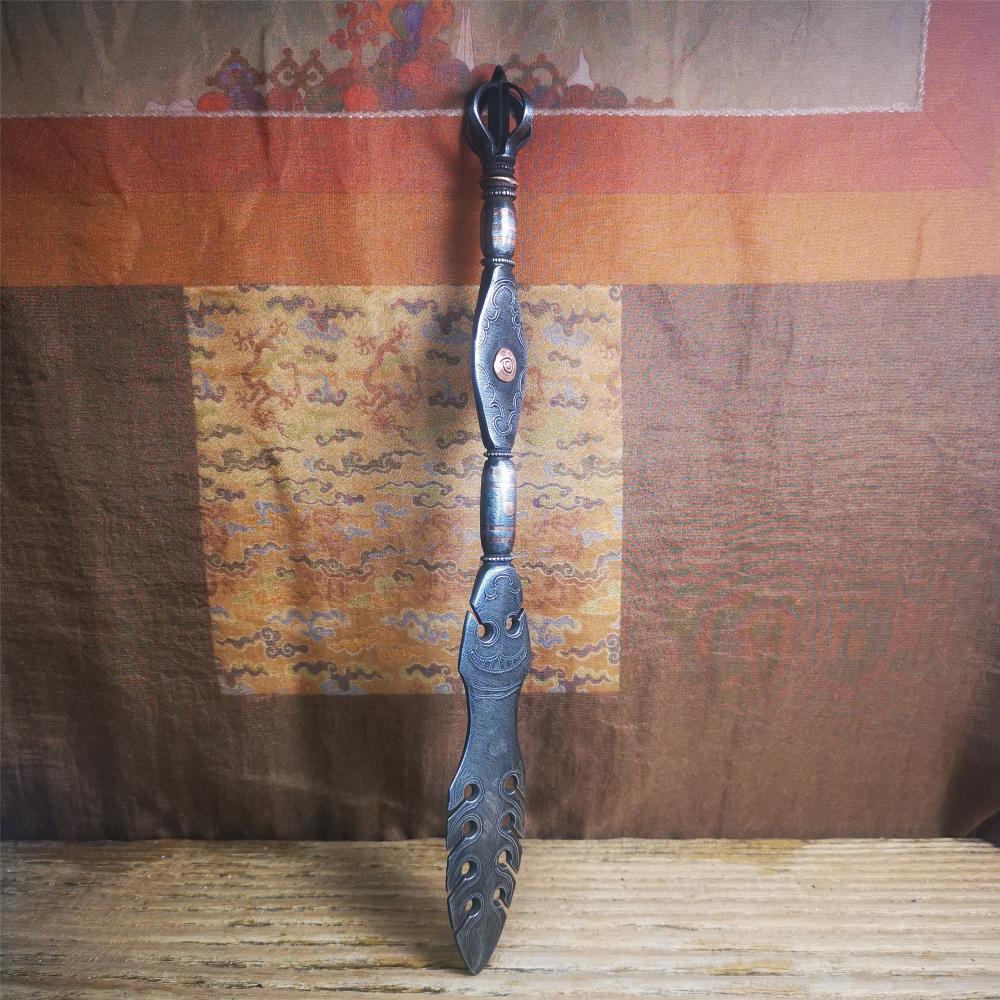 This vajra sword was handmade by Tibetan craftsmen from Tibet in 1990s,from Hepo Town, Baiyu County. It's a manjusri sword shape,flame shape blade,made of cold iron, carved conch pattern,and the vajra of the tail hanging ring