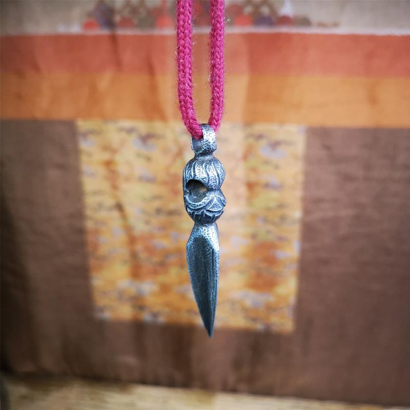This phurba was made by Tibetan craftsmen and come from Hepo Town, Baiyu County, the birthplace of the famous Tibetan handicrafts. Its upper part is Shmashana Adhipati skull, the lower part is a Dorje Phurba