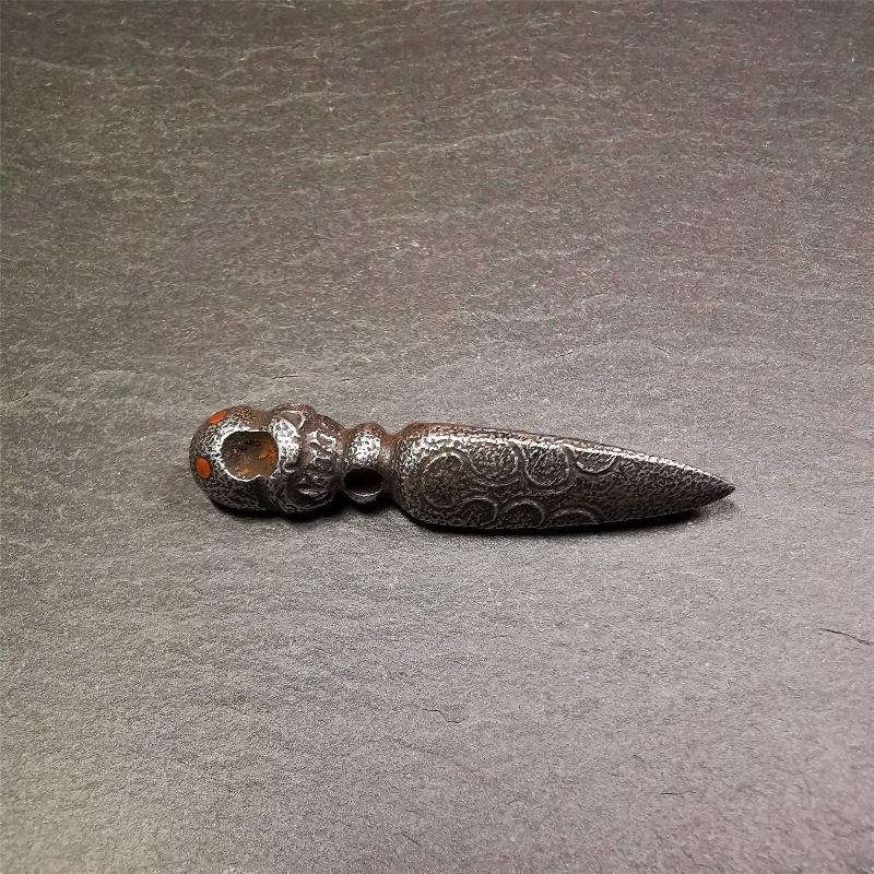 This phurba was made by Tibetan craftsmen and come from Hepo Town, Baiyu County, the birthplace of the famous Tibetan handicrafts. Its upper part is Shmashana Adhipati skull, the lower part is a Dorje Phurba, three copper dots inlaid on it