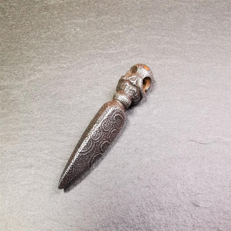 This phurba was made by Tibetan craftsmen and come from Hepo Town, Baiyu County, the birthplace of the famous Tibetan handicrafts. Its upper part is Shmashana Adhipati skull, the lower part is a Dorje Phurba, three copper dots inlaid on it