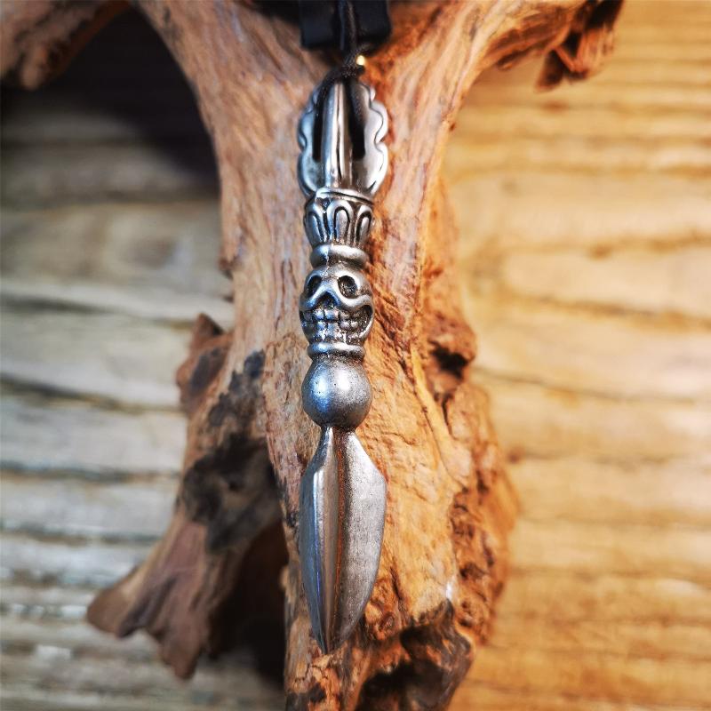 This phurba amulet was made of cold iron by Tibetan craftsmen in 1990's,its upper part is a vajra,and carved Shmashana Adhipati skull in the middle, the lower part is a Dorje Phurba,length is 3.0inches