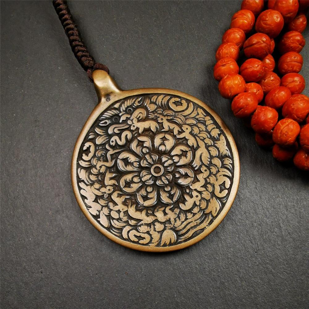 This unique meling amulet is handmade in Baiyu County Tibet,Where is the famous handicraft industry base in Tibetan areas. It is made of lima brass,2.16 inches diameter,the front center is a very rare mandala flower shape.