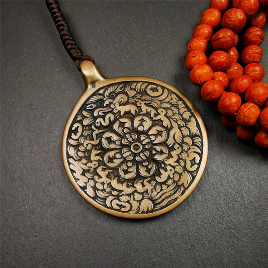 This unique meling amulet is handmade in Baiyu County Tibet,Where is the famous handicraft industry base in Tibetan areas.  It is made of lima brass,2.16 inches diameter,the front center is a very rare mandala flower shape.