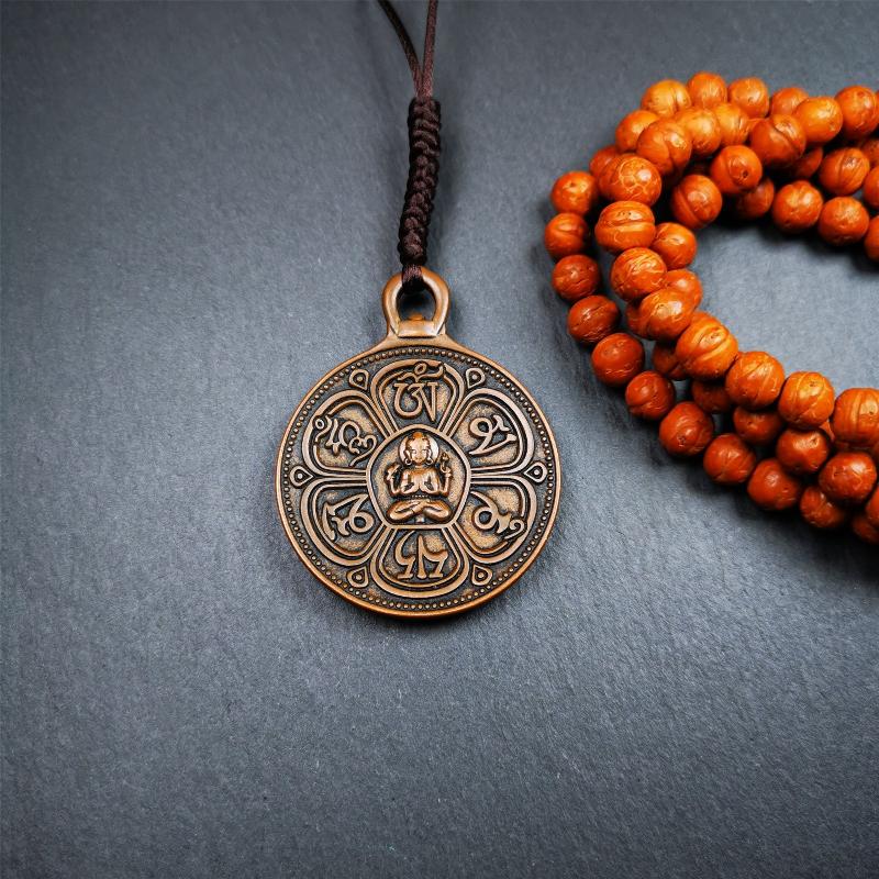 This OM badge amulet was collected from Jiegu Monastery Tibet.It is made of copper,diameter is 1.65 inches,Chenrezig is on the center, carved with Tibetan Letter ,Om Mani Padme Hum mantra,the letter on the back is Mind