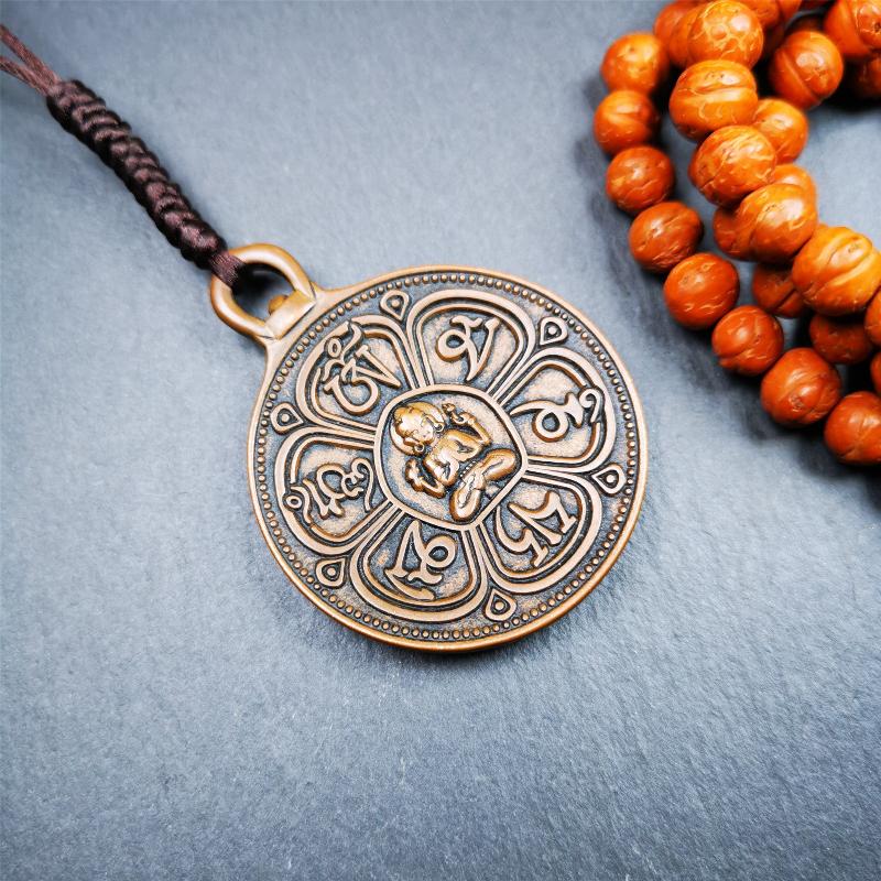 This OM badge amulet was collected from Jiegu Monastery Tibet.It is made of copper,diameter is 1.65 inches,Chenrezig is on the center, carved with Tibetan Letter ,Om Mani Padme Hum mantra,the letter on the back is Mind