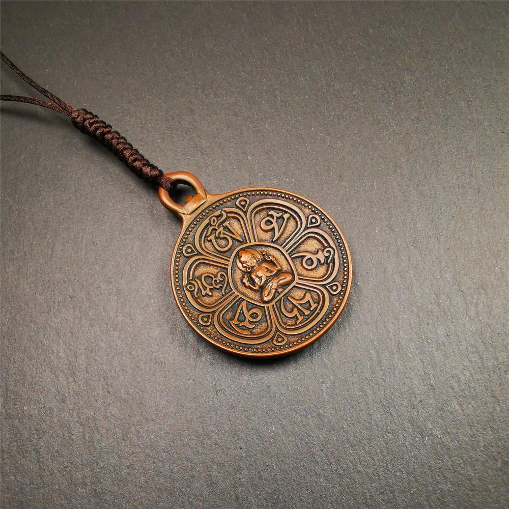 This OM badge amulet was collected from Jiegu Monastery Tibet.It is made of copper,diameter is 1.65 inches,Chenrezig is on the center, carved with Tibetan Letter ,Om Mani Padme Hum mantra,the letter on the back is Mind