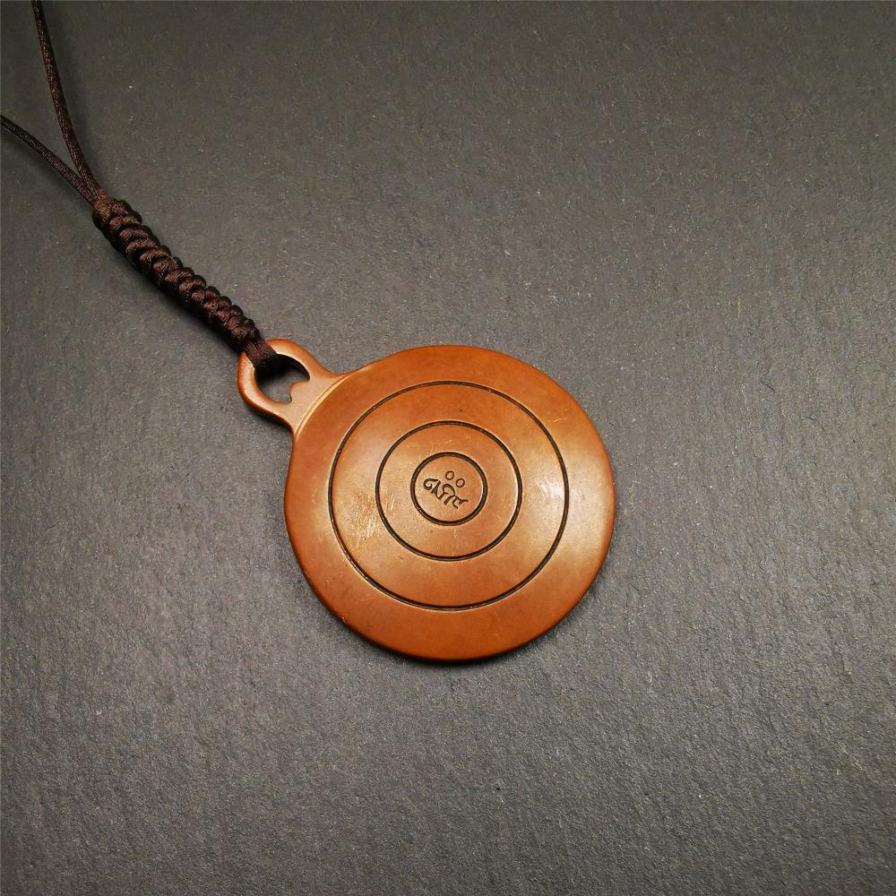 This OM badge amulet was collected from Jiegu Monastery Tibet.It is made of copper,diameter is 1.65 inches,Chenrezig is on the center, carved with Tibetan Letter ,Om Mani Padme Hum mantra,the letter on the back is Mind