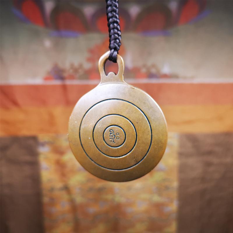 This OM badge amulet was collected from Jiegu Monastery Tibet.It is made of copper,diameter is 1.65 inches,Chenrezig is on the center, carved with Tibetan Letter ,Om Mani Padme Hum mantra,the letter on the back is Mind