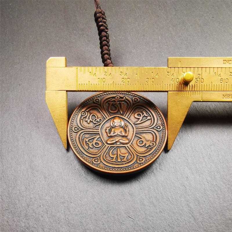 This OM badge amulet was collected from Jiegu Monastery Tibet.It is made of copper,diameter is 1.65 inches,Chenrezig is on the center, carved with Tibetan Letter ,Om Mani Padme Hum mantra,the letter on the back is Mind