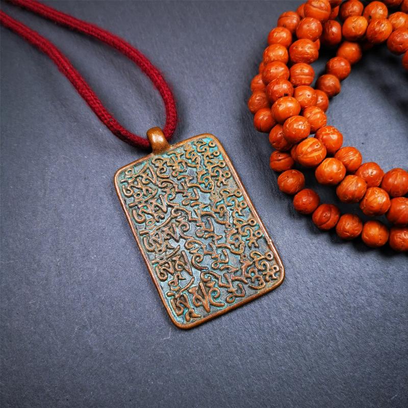 This badge is made by Tibetan craftsmen from Hepo Town, Baiyu County, the birthplace of the famous Tibetan handicrafts. It is made of copper, 2.44 × 1.42 inches. The front is the OM mantra and the back is body, speech, and mind.
