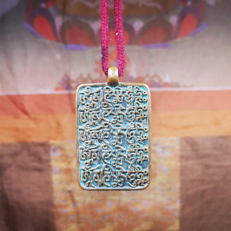 This badge is made by Tibetan craftsmen from Hepo Town, Baiyu County, the birthplace of the famous Tibetan handicrafts. It is made of copper, 2.44 × 1.42 inches. The front is the OM mantra and the back is body, speech, and mind.