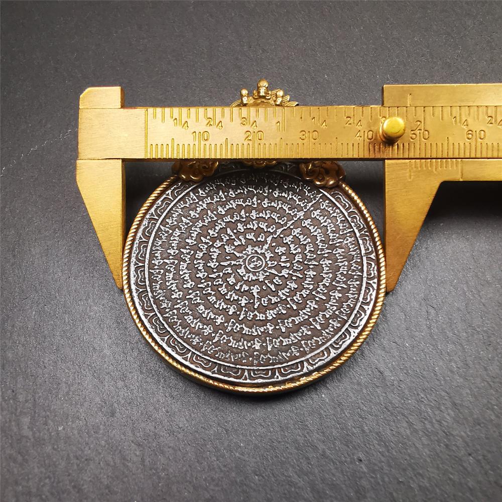 This type of tibetan mantra badge amulet was made by Tibetan craftsmen and come from Hepo Town, Baiyu County, Tibet.It is made of cold iron,grey color,carved mantra of Om Mani Padme Hum It adopts a split casting method, the shell is Mahakala.