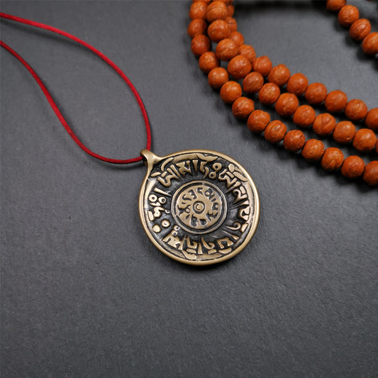 This Om badge amulet was collected from Yushu City Tibet,about 50 years old. It is round shape,made of lima brass, 1.58 inches,carved with mantra of chenrezig OM MANI PADME HUM. You can make it into a necklace, or a keychain, pendant
