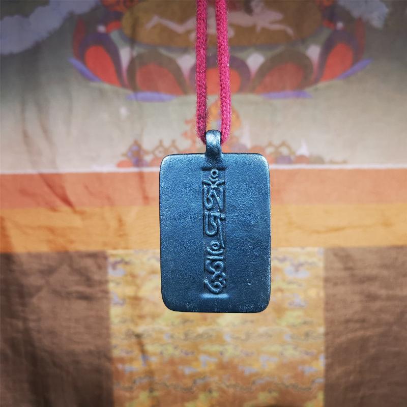 This badge is made by Tibetan craftsmen from Hepo Town, Baiyu County, the birthplace of the famous Tibetan handicrafts. It is made of copper, 2.52 × 1.57 inches. The front is the OM mantra and the back is body, speech, and mind.