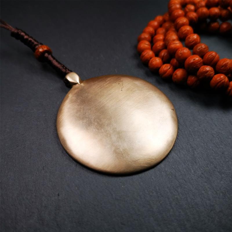 This type of melong amulet was made by Tibetan craftsmen and come from Hepo Town, Baiyu County, the birthplace of the famous Tibetan handicrafts,blessed by lama from Rejia Monastery,about 30 years old. It is made of lima brass,round shape,2.16 inches
