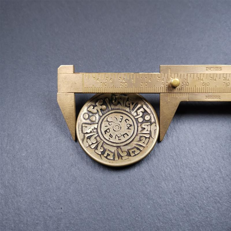 This Om badge amulet was collected from Yushu City Tibet,about 50 years old. It is round shape,made of lima brass, 1.65 inches,carved with mantra of chenrezig OM MANI PADME HUM. You can make it into a necklace, or a keychain, pendant
