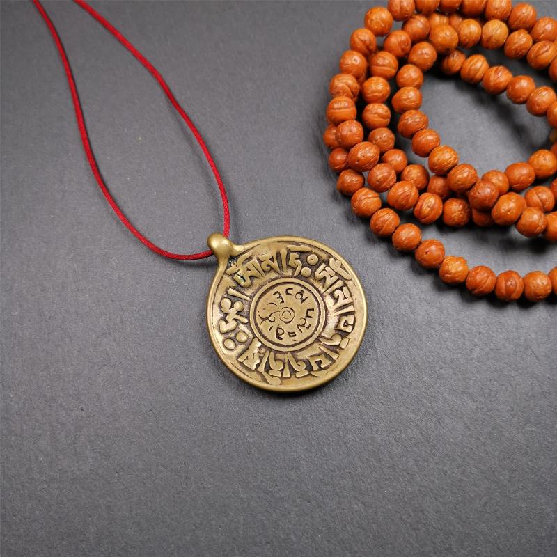 This Om badge amulet was collected from Yushu City Tibet,about 50 years old. It is round shape,made of lima brass, 1.65 inches,carved with mantra of chenrezig OM MANI PADME HUM. You can make it into a necklace, or a keychain, pendant