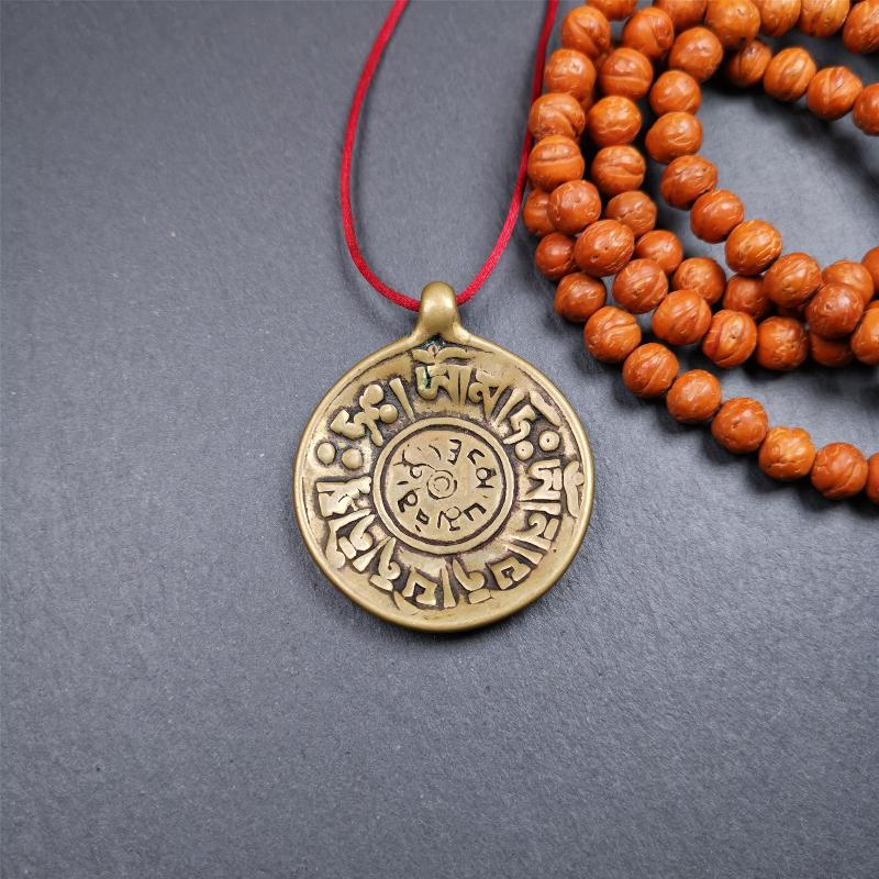 This Om badge amulet was collected from Yushu City Tibet,about 50 years old. It is round shape,made of lima brass, 1.65 inches,carved with mantra of chenrezig OM MANI PADME HUM. You can make it into a necklace, or a keychain, pendant