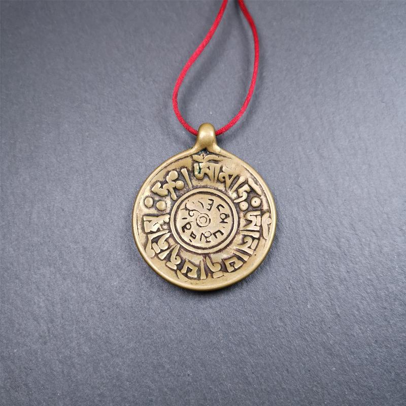 This Om badge amulet was collected from Yushu City Tibet,about 50 years old. It is round shape,made of lima brass, 1.65 inches,carved with mantra of chenrezig OM MANI PADME HUM. You can make it into a necklace, or a keychain, pendant