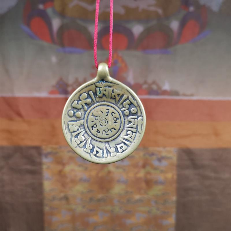 This Om badge amulet was collected from Yushu City Tibet,about 50 years old. It is round shape,made of lima brass, 1.65 inches,carved with mantra of chenrezig OM MANI PADME HUM. You can make it into a necklace, or a keychain, pendant