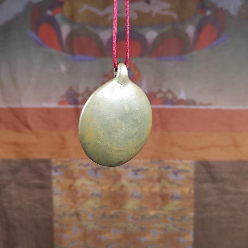 This Om badge amulet was collected from Yushu City Tibet,about 50 years old. It is round shape,made of lima brass, 1.65 inches,carved with mantra of chenrezig OM MANI PADME HUM. You can make it into a necklace, or a keychain, pendant