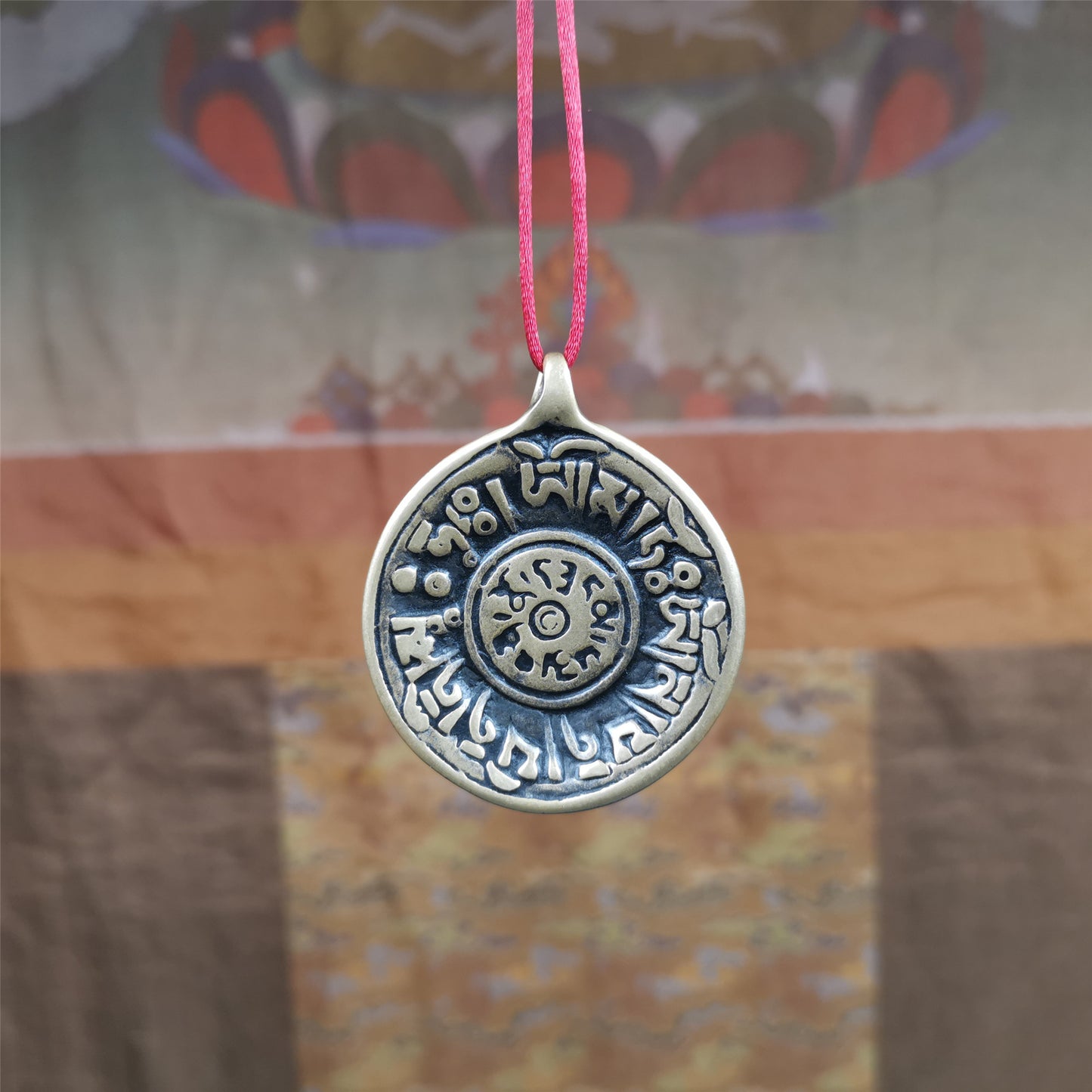 This Om badge amulet was collected from Yushu City Tibet,about 50 years old. It is round shape,made of lima brass, 1.58 inches,carved with mantra of chenrezig OM MANI PADME HUM. You can make it into a necklace, or a keychain, pendant