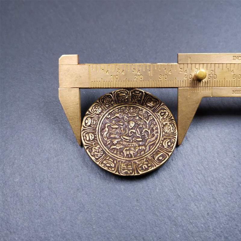 This Longevity Badge was handmade by Tibetan craftsmen and come from Hepo Town, Baiyu County, Tibet. It is made of brass,round shape,the theme is the god of longevity,surrounded by the symbols of Ashtamangala.