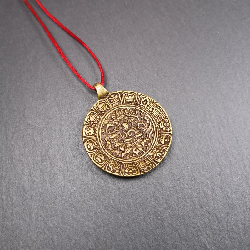This Longevity Badge was handmade by Tibetan craftsmen and come from Hepo Town, Baiyu County, Tibet. It is made of brass,round shape,the theme is the god of longevity,surrounded by the symbols of Ashtamangala.