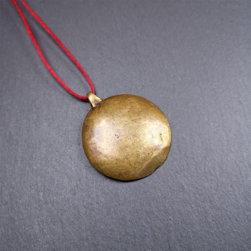 This Longevity Badge was handmade by Tibetan craftsmen and come from Hepo Town, Baiyu County, Tibet. It is made of brass,round shape,the theme is the god of longevity,surrounded by the symbols of Ashtamangala.