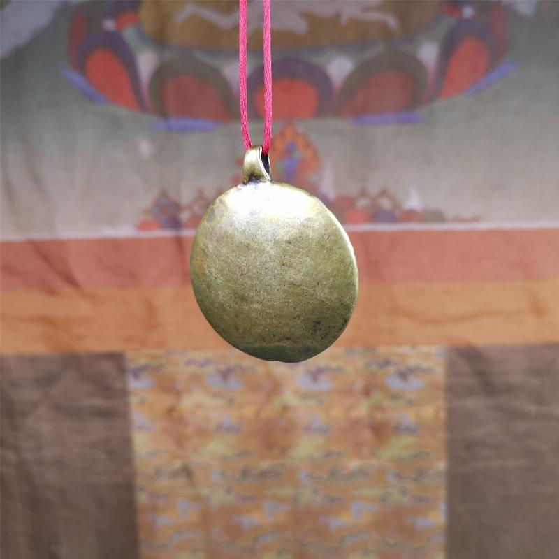 This Longevity Badge was handmade by Tibetan craftsmen and come from Hepo Town, Baiyu County, Tibet. It is made of brass,round shape,the theme is the god of longevity,surrounded by the symbols of Ashtamangala.