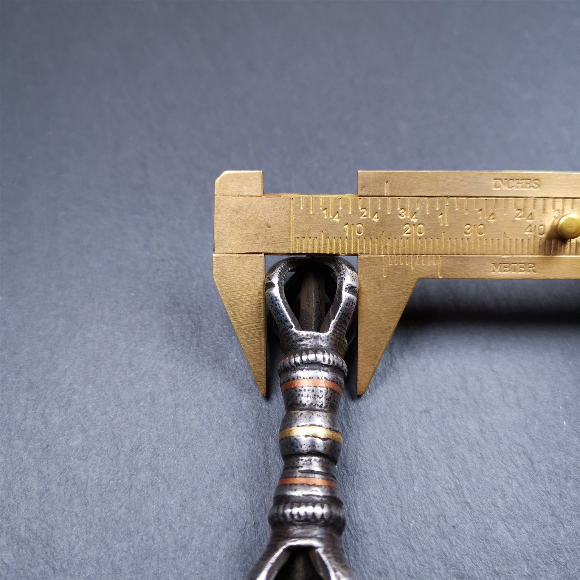 This unique vajra pendant was handmade by Tibetan craftsmen from Tibet in 1990s,from Hepo Town, Baiyu County, the birthplace of the famous Tibetan handicrafts. It is five - pronged Vajra,made of cold iron, black color,2.95 inches length.