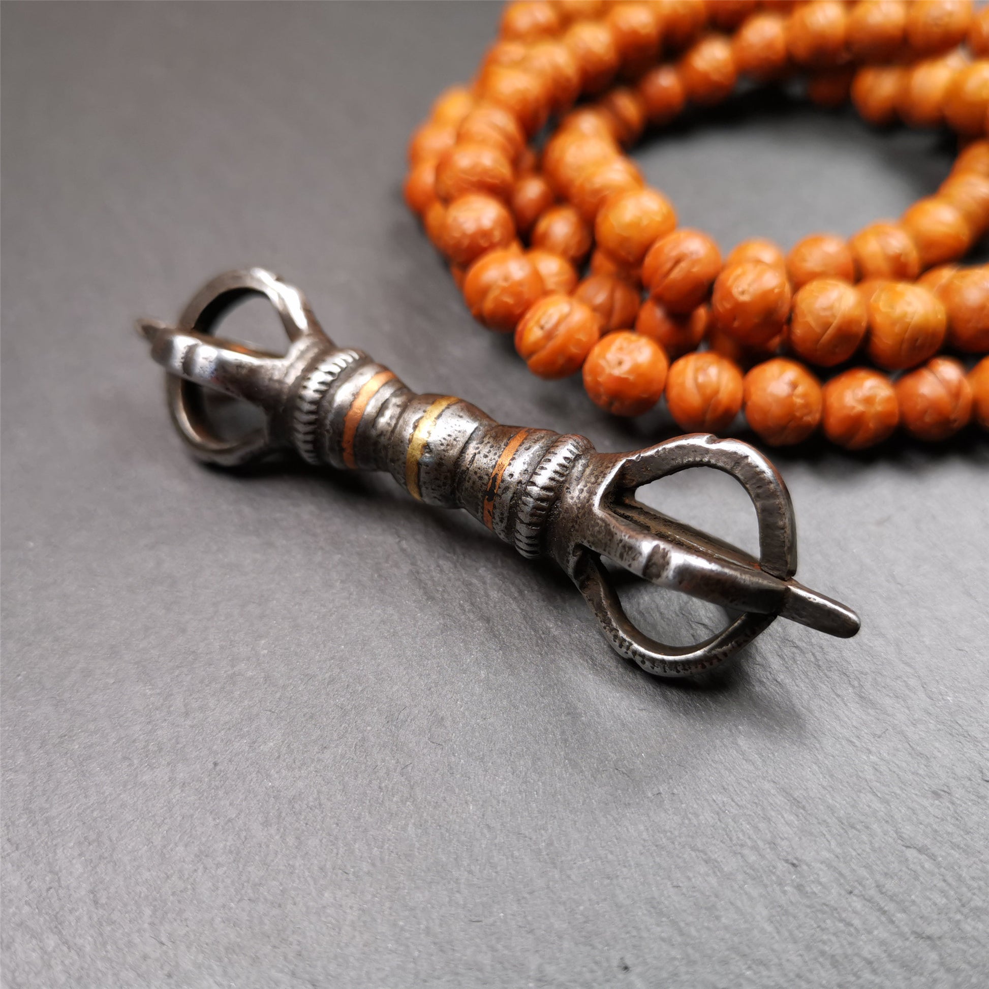This unique vajra pendant was handmade by Tibetan craftsmen from Tibet in 1990s,from Hepo Town, Baiyu County, the birthplace of the famous Tibetan handicrafts. It is five - pronged Vajra,made of cold iron, black color,2.95 inches length.