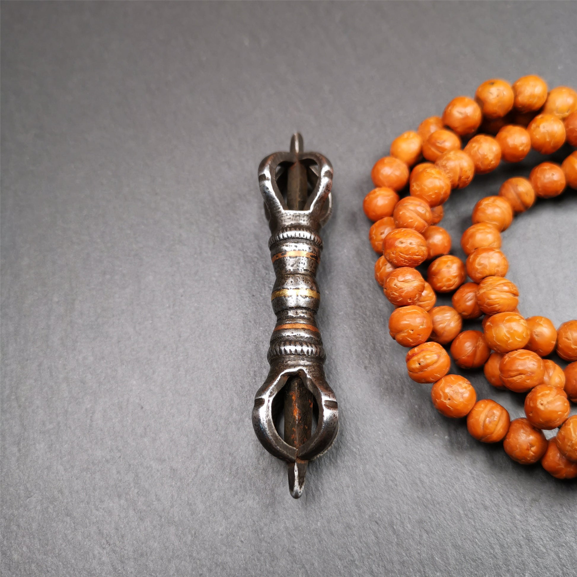 This unique vajra pendant was handmade by Tibetan craftsmen from Tibet in 1990s,from Hepo Town, Baiyu County, the birthplace of the famous Tibetan handicrafts. It is five - pronged Vajra,made of cold iron, black color,2.95 inches length.